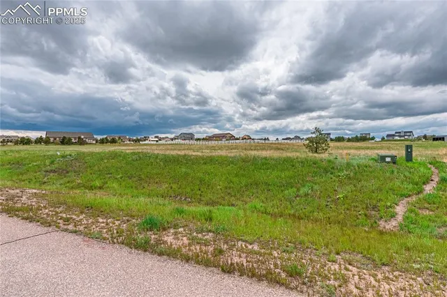 a view of a big yard with an outdoor seating space