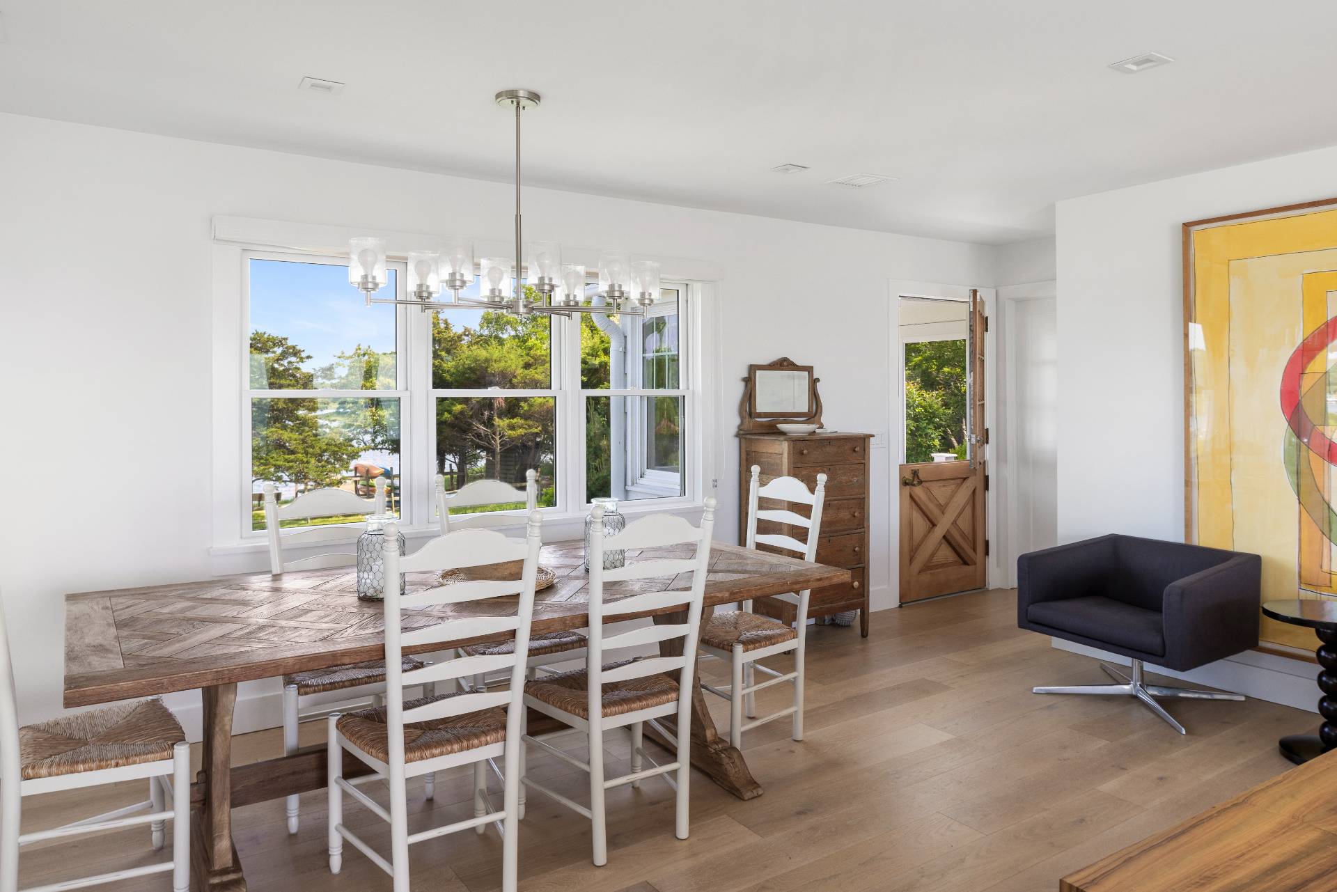 48 Bay Inlet Road East Hampton, NY 11937 - Photo 11 of 46 a dining room with furniture a chandelier and wooden floor