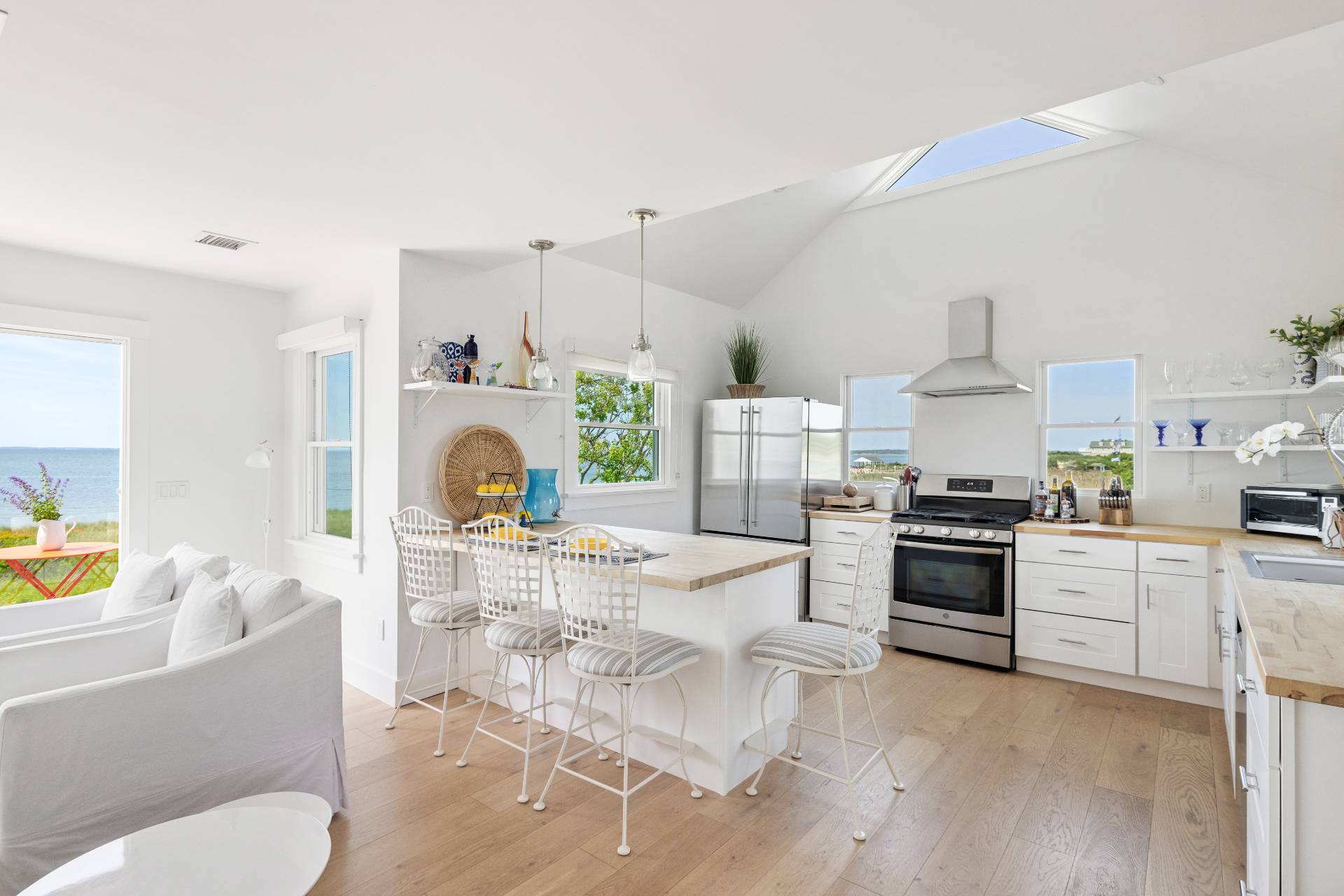 48 Bay Inlet Road East Hampton, NY 11937 - Photo 12 of 46 a living room with furniture a fireplace and a kitchen view