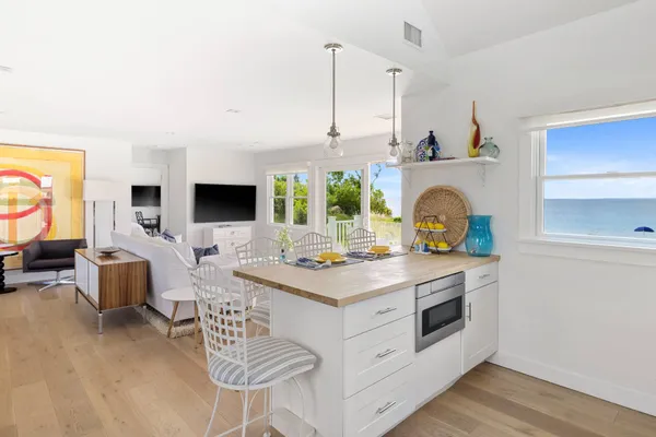 a kitchen with a stove and a white wooden cabinets