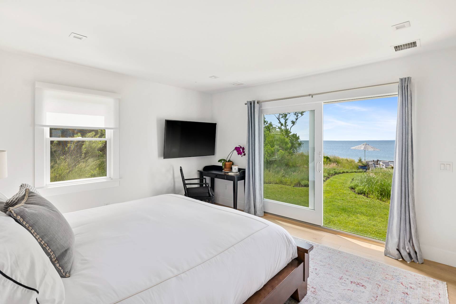 48 Bay Inlet Road East Hampton, NY 11937 - Photo 16 of 46 a bedroom with a bed and a flat screen tv