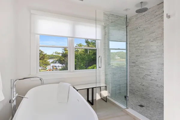 a bathroom with a bathtub and shower