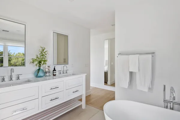 a bathroom with a double vanity sink toilet and shower