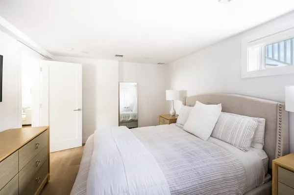 a large white bed in a white room