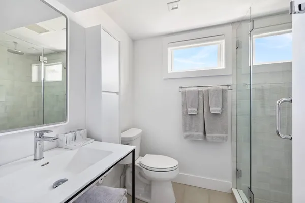 a bathroom with a sink toilet and shower