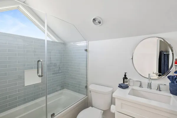 a bathroom with a sink toilet and shower