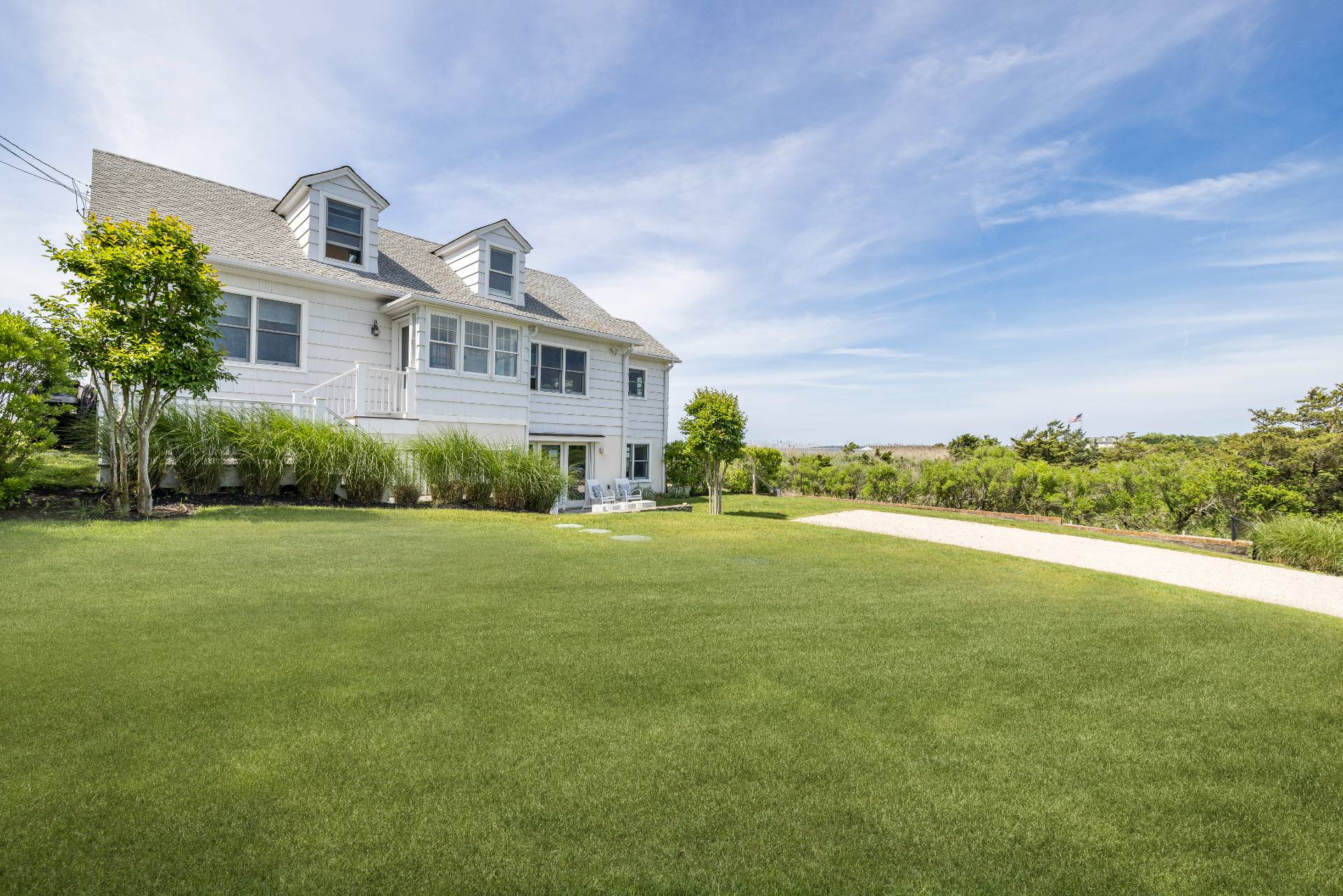 48 Bay Inlet Road East Hampton, NY 11937 - Photo 3 of 46 a front view of a house with a garden