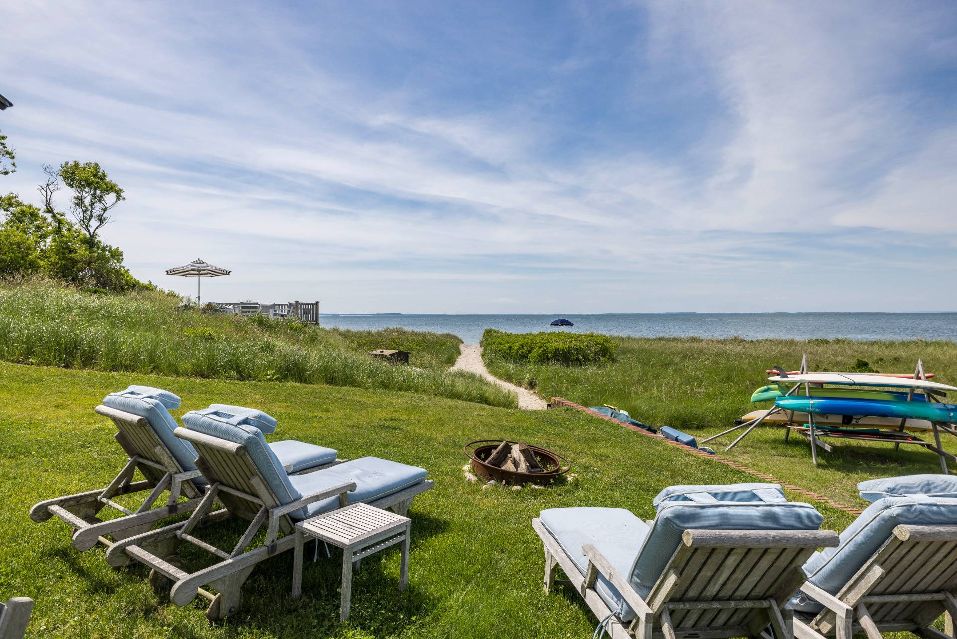 48 Bay Inlet Road East Hampton, NY 11937 - Photo 35 of 46 a view of a swimming pool and lounge chairs in back yard of the house