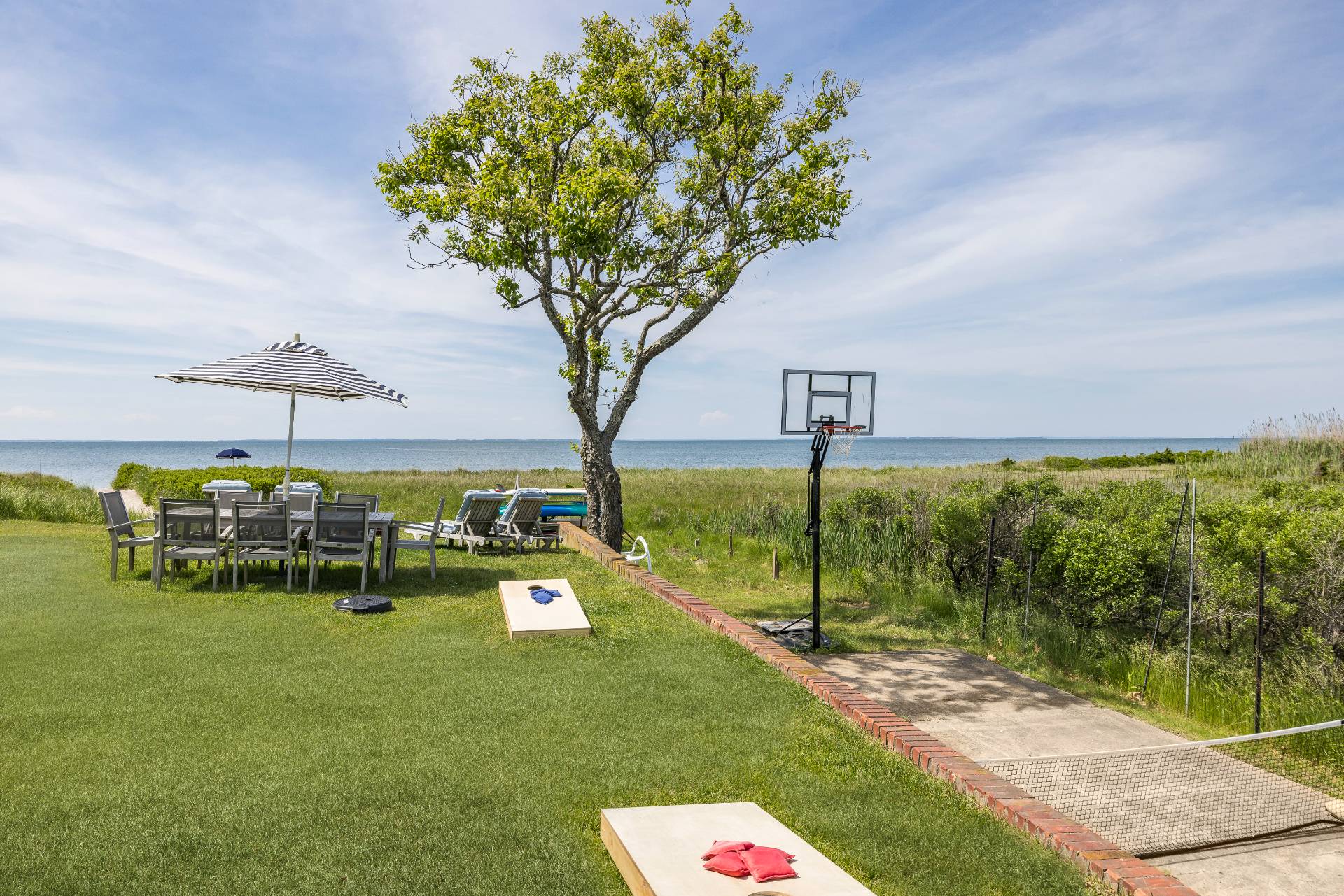 48 Bay Inlet Road East Hampton, NY 11937 - Photo 36 of 46 a view of a bench in front of house