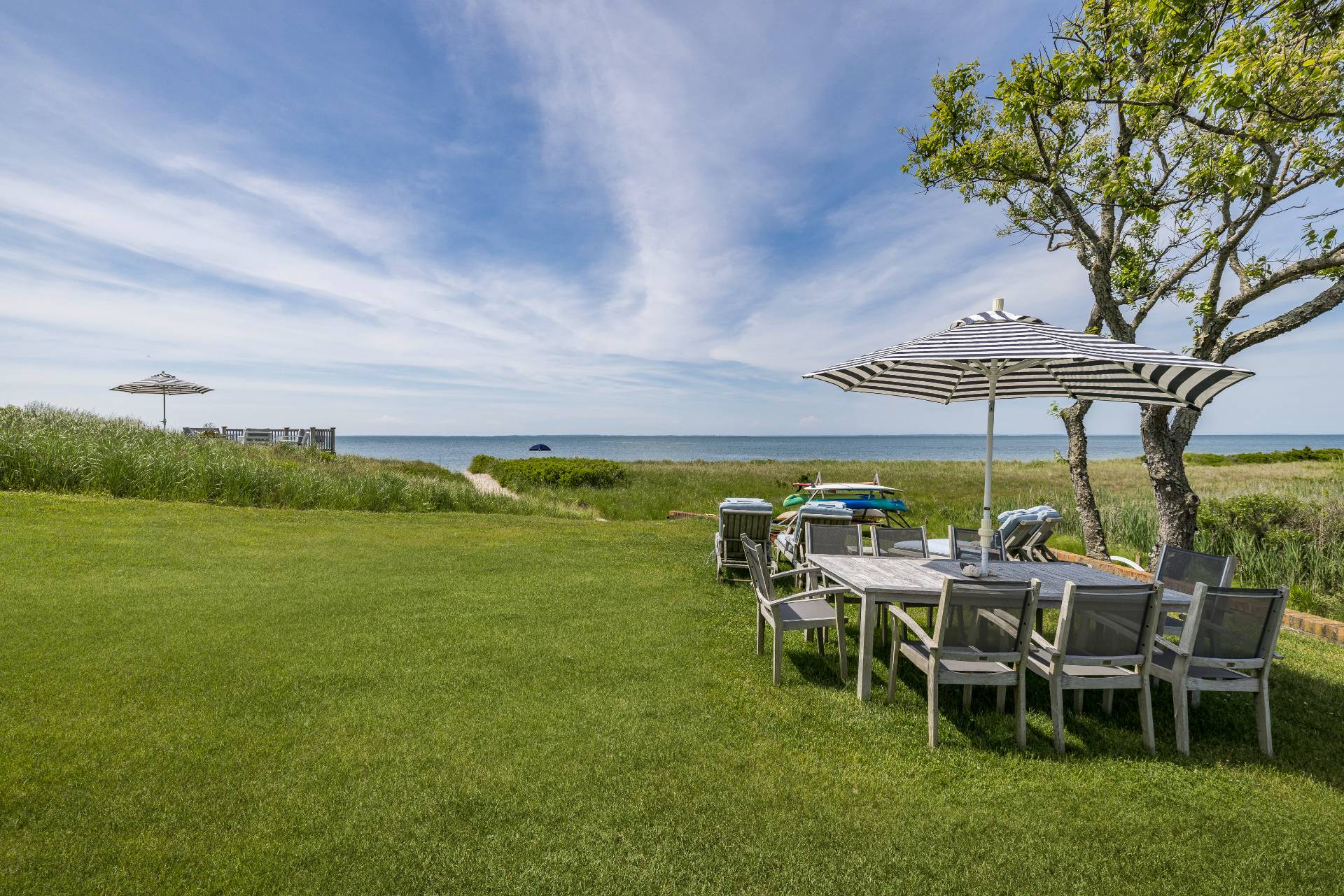 48 Bay Inlet Road East Hampton, NY 11937 - Photo 37 of 46 a view of a table and chairs in the garden