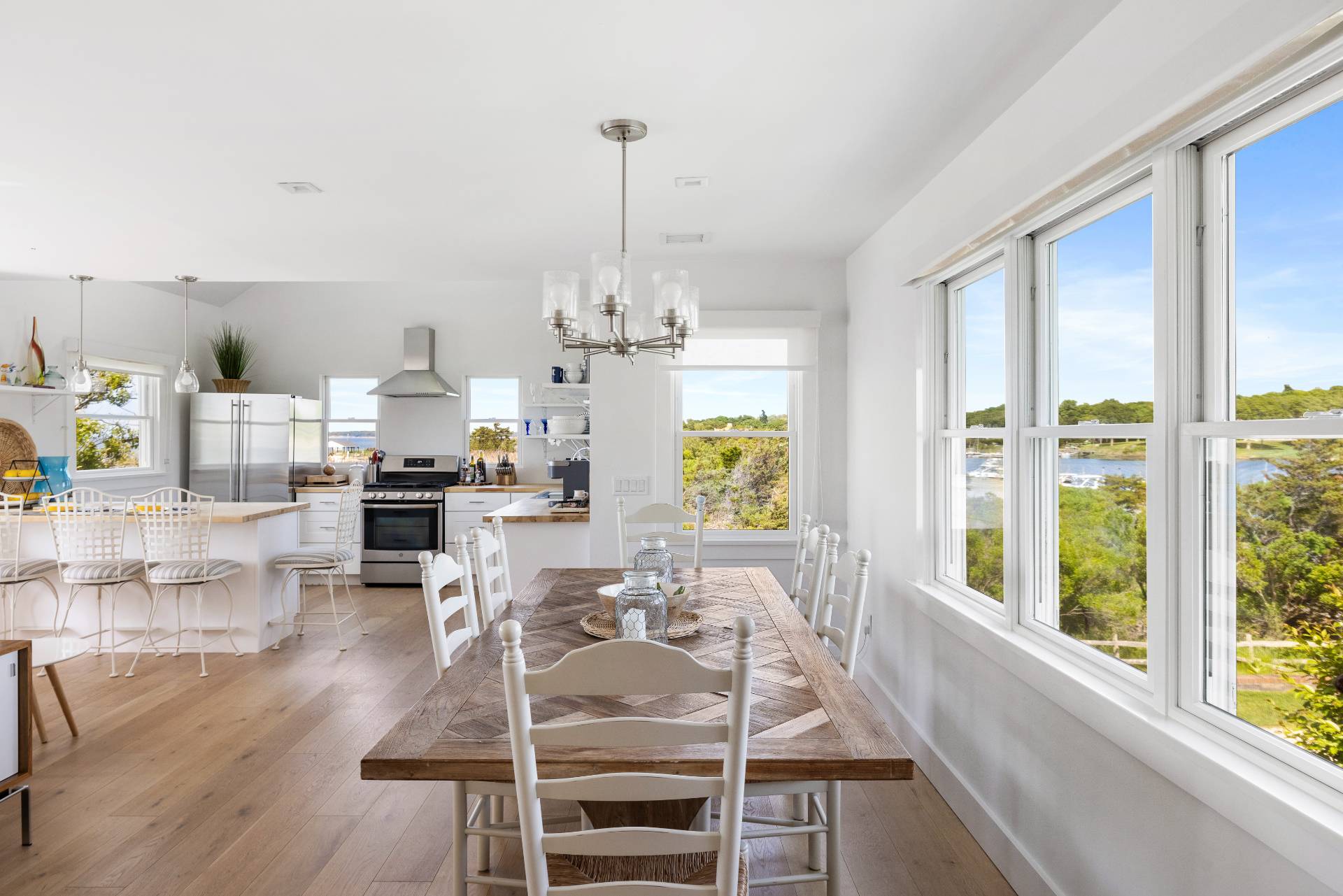 48 Bay Inlet Road East Hampton, NY 11937 - Photo 8 of 46 a view of a dining room and livingroom with furniture wooden floor a chandelier