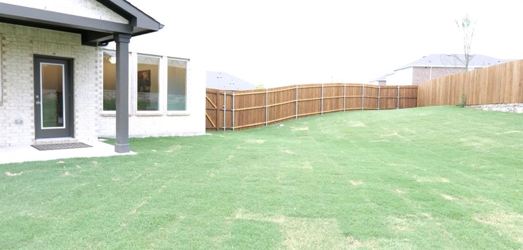 502 Virginia Way Princeton, TX 75407 - Photo 3 of 9 Expansive green lawn with a full privacy fence