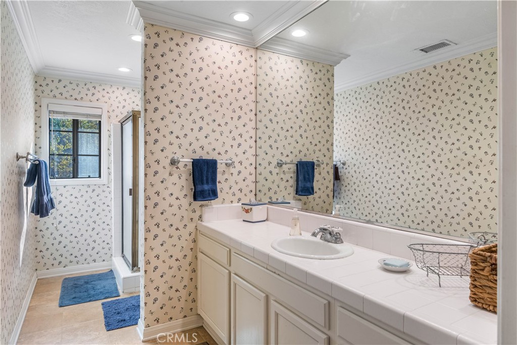 63 Ranchview Road Rolling Hills Estates, CA 90274 - Photo 11 of 28 a bathroom with a sink a mirror and shower