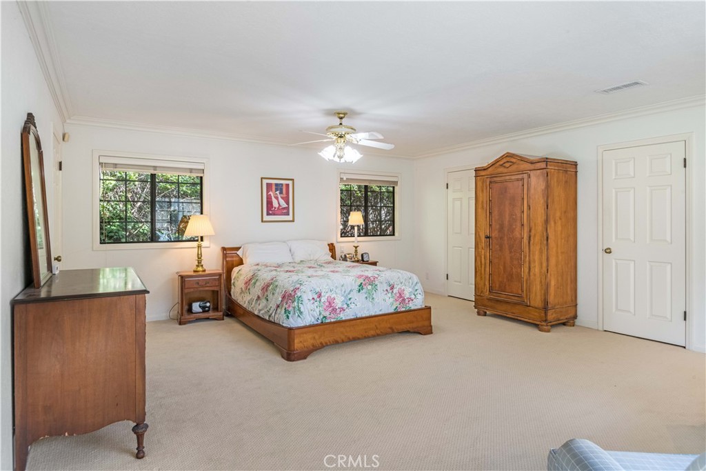 63 Ranchview Road Rolling Hills Estates, CA 90274 - Photo 17 of 28 a bedroom with a large bed and a chandelier