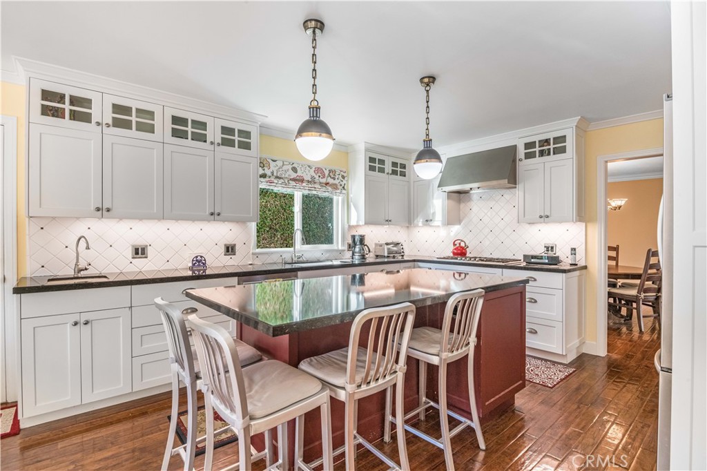 63 Ranchview Road Rolling Hills Estates, CA 90274 - Photo 3 of 28 a kitchen with a dining table chairs sink and cabinets
