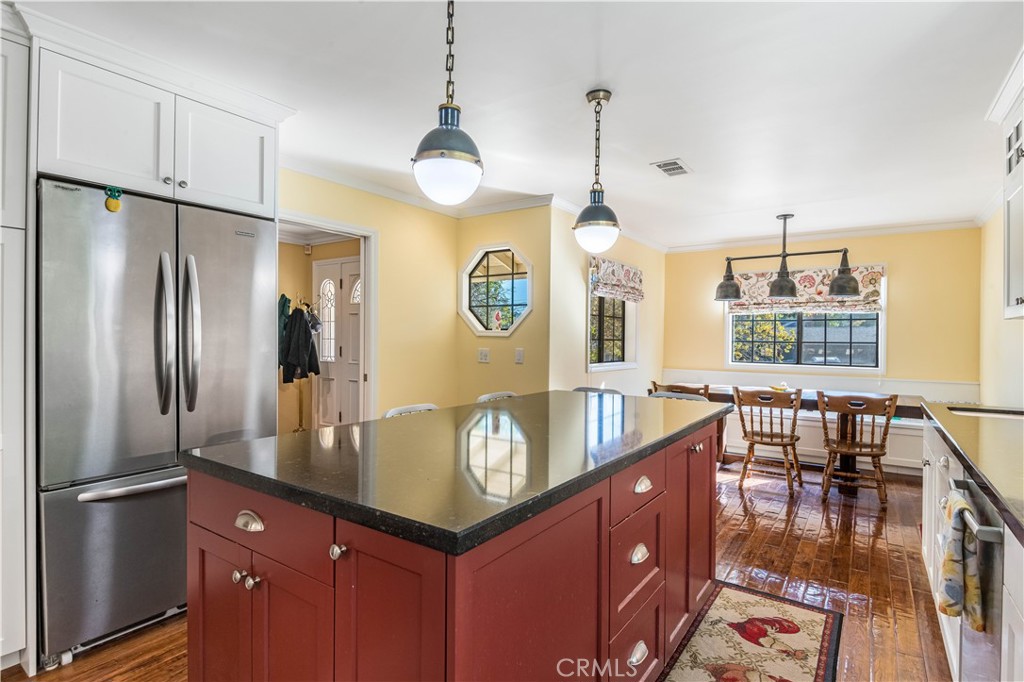 63 Ranchview Road Rolling Hills Estates, CA 90274 - Photo 5 of 28 a kitchen with stainless steel appliances granite countertop a refrigerator a stove and a dining table with wooden floor