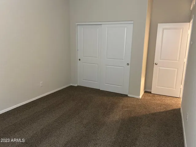 an empty room with closet area