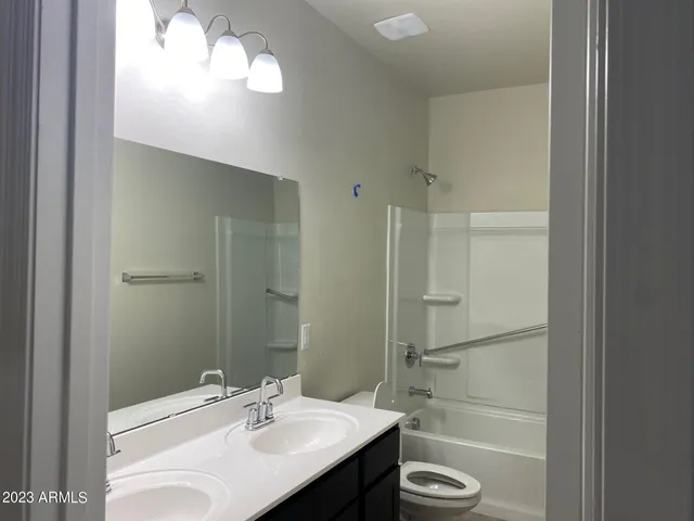 a bathroom with a sink vanity toilet and shower