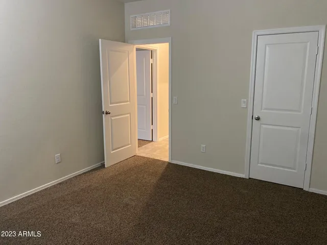 an empty room with closet area