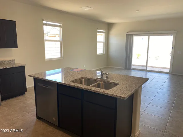 a kitchen with a sink and a mirror