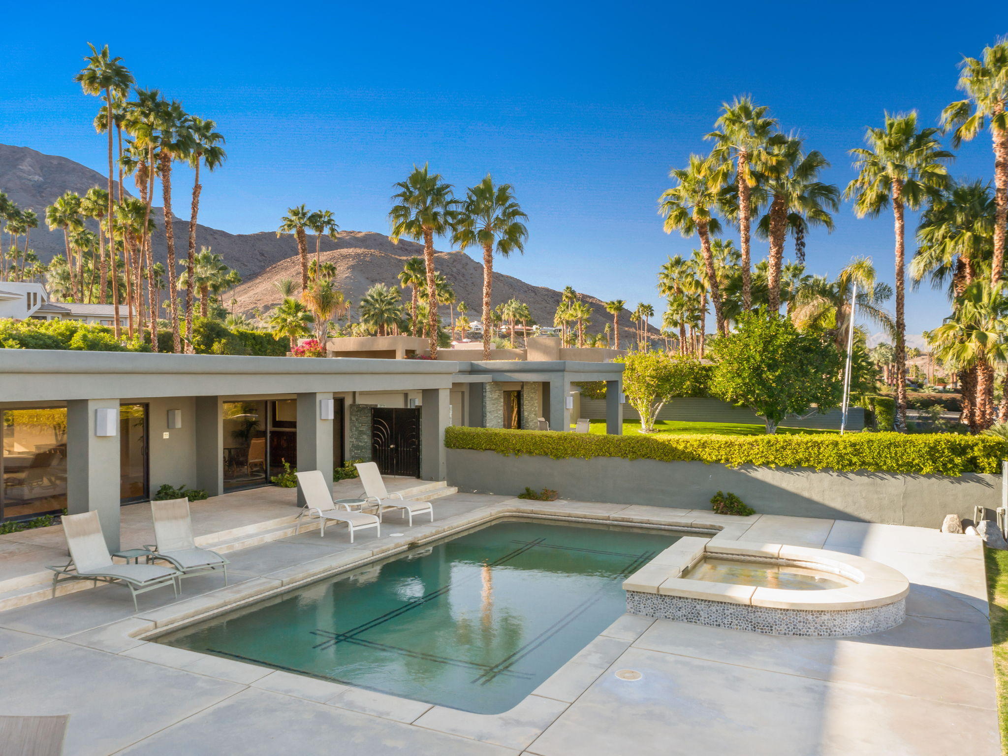 70291 Pecos Road Rancho Mirage, CA 92270 - Photo 3 of 65 a view of a house with swimming pool and sitting area