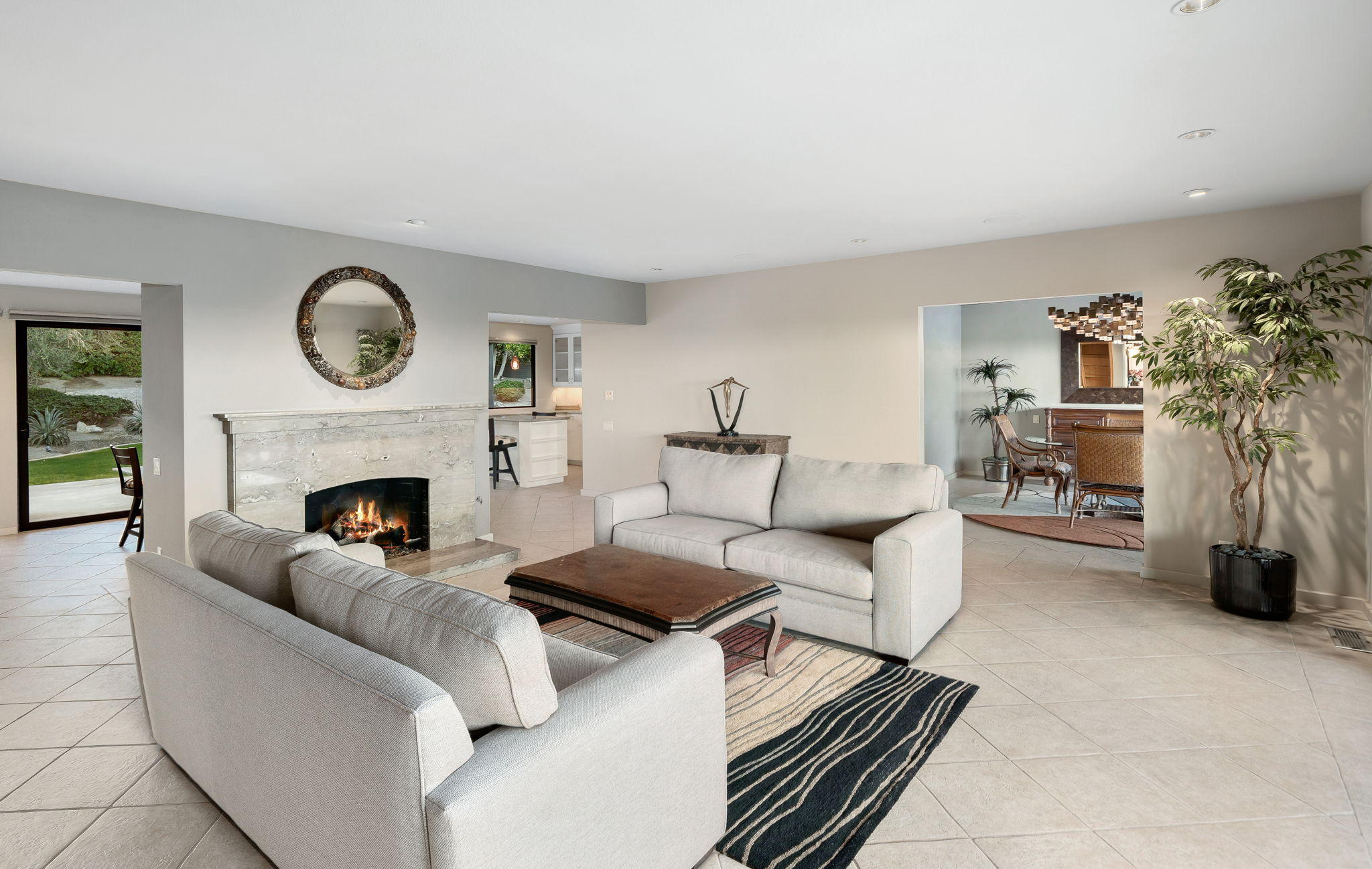 70291 Pecos Road Rancho Mirage, CA 92270 - Photo 22 of 65 a living room with furniture a fireplace and a potted plant