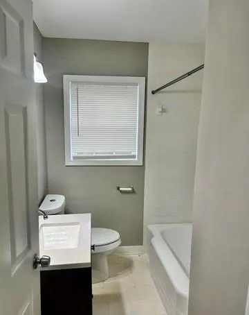a bathroom with a toilet a sink and a mirror