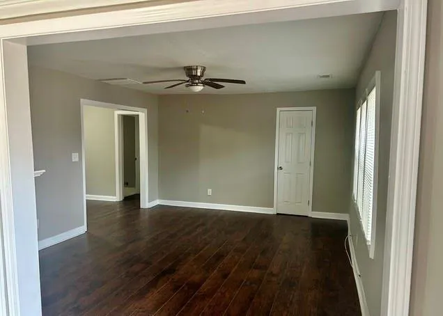 a view of a hallway with wooden floor