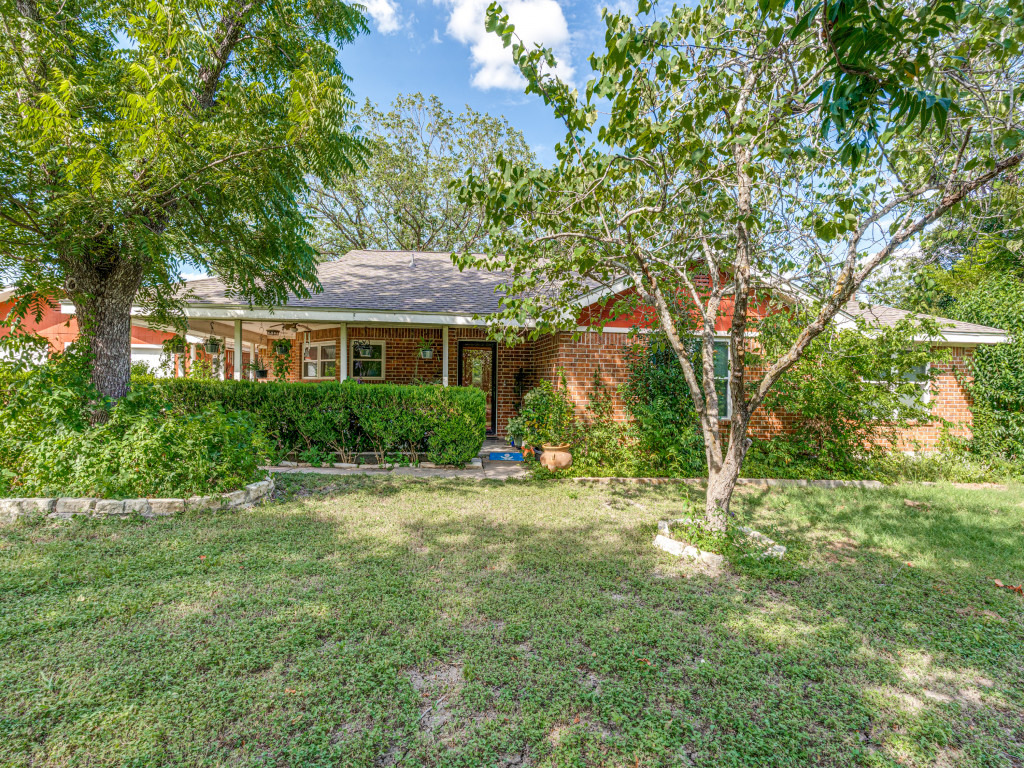1035 Palomino Road Kyle, TX 78640 - Photo 3 of 13 A classic brick exterior, framed by mature trees, welcomes you home.