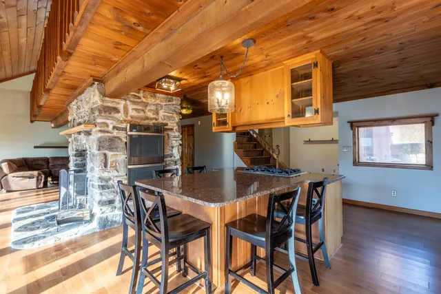 a view of a house with a yard and large tree