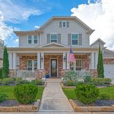front view of a brick house with a yard