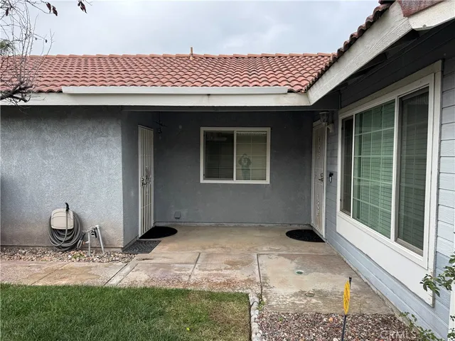 wooden floor fireplace and windows in an empty room