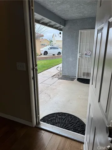 a view of empty room with wooden floor and fireplace
