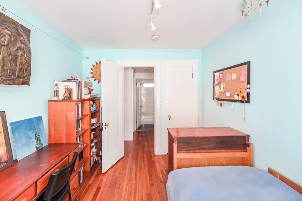 20 Stoneleigh Road, Unit 20 Newton, MA 02465 - Photo 13 of 30 a bedroom with furniture and wooden floor