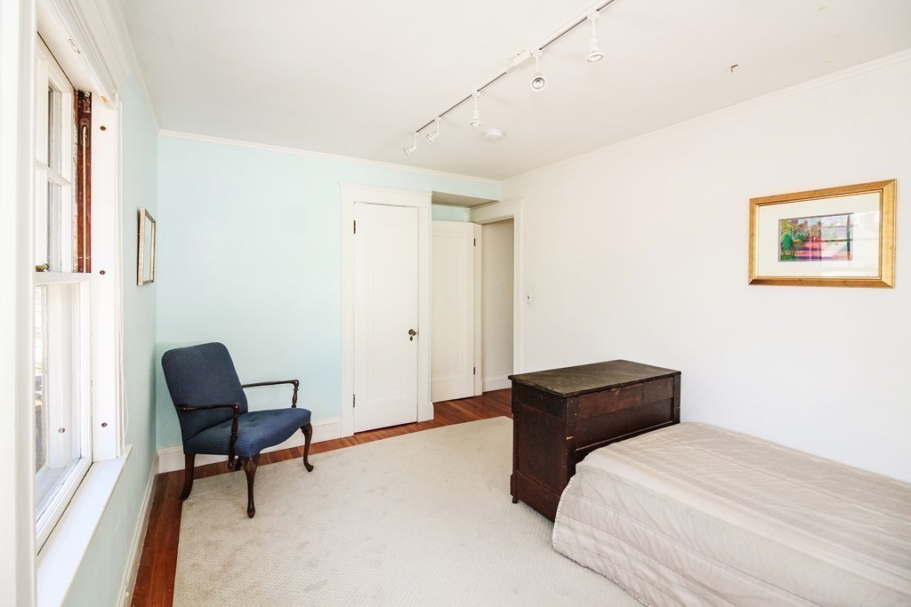 20 Stoneleigh Road, Unit 20 Newton, MA 02465 - Photo 15 of 30 a bedroom with a bed and a chair