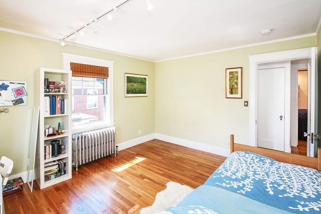 20 Stoneleigh Road, Unit 20 Newton, MA 02465 - Photo 17 of 30 a bedroom with furniture and wooden floor