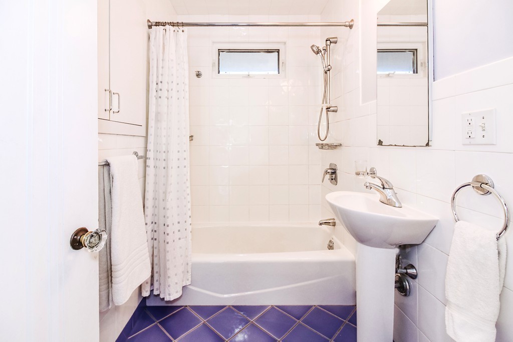 20 Stoneleigh Road, Unit 20 Newton, MA 02465 - Photo 18 of 30 a bathroom with a sink a mirror and a bathtub