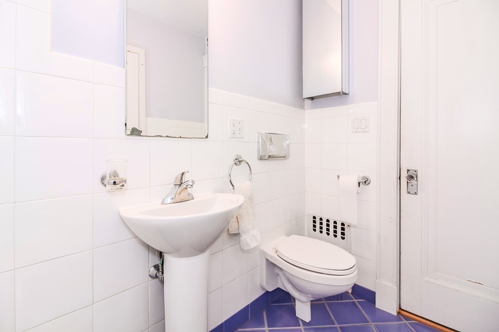 20 Stoneleigh Road, Unit 20 Newton, MA 02465 - Photo 19 of 30 a bathroom with a sink toilet and mirror