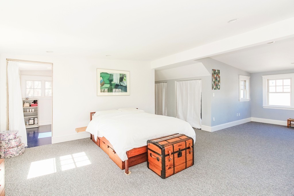 20 Stoneleigh Road, Unit 20 Newton, MA 02465 - Photo 24 of 30 a bedroom with a bed and a painting on the wall