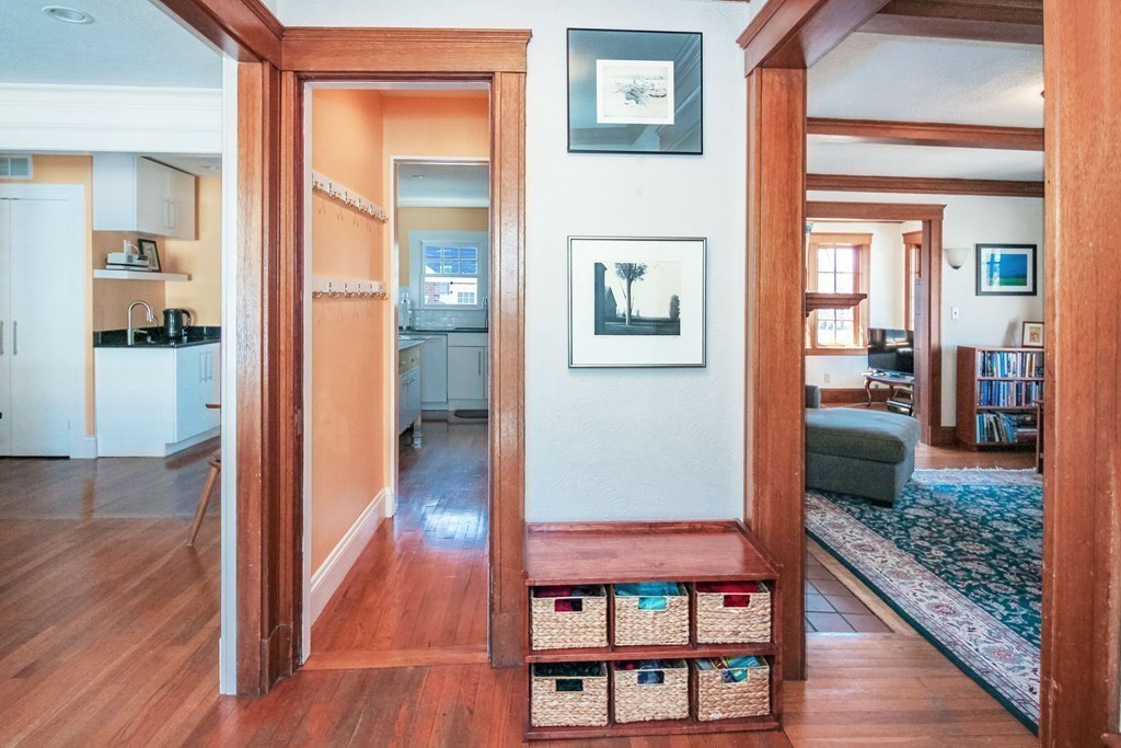 20 Stoneleigh Road, Unit 20 Newton, MA 02465 - Photo 6 of 30 a view of a hallway with wooden floor and living room