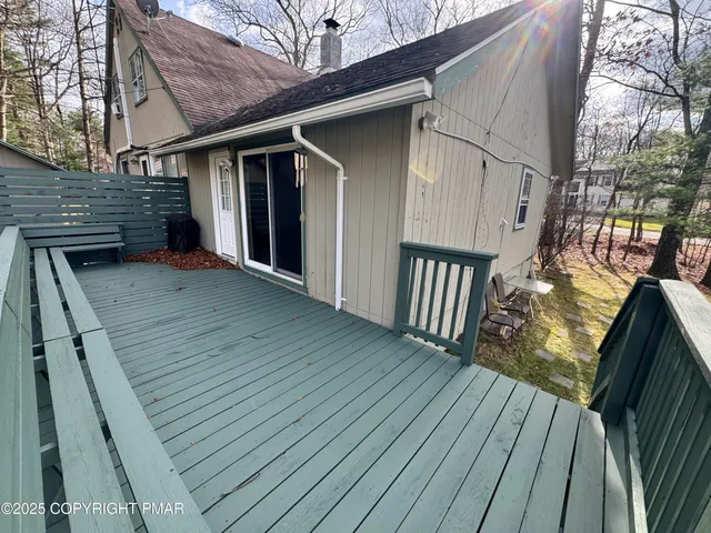 a view of backyard with wooden deck and floor