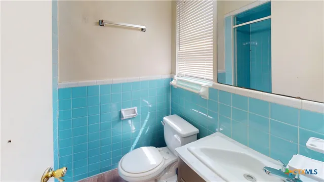 a bathroom with a toilet and a sink