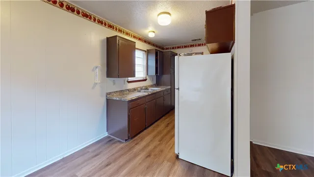 a kitchen with stainless steel appliances granite countertop a stove a refrigerator and a microwave