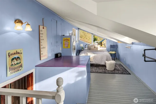 a living room with furniture and a baby crib