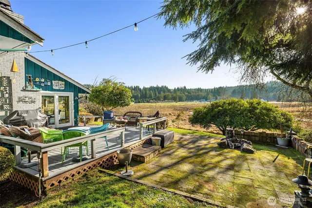 a view of a swimming pool with a patio and a yard
