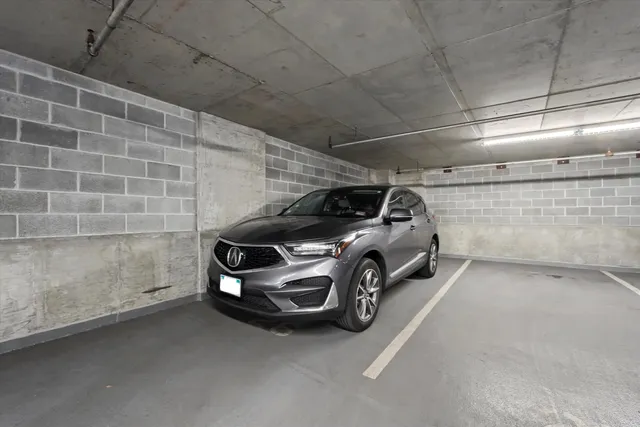 a view of parking garage with cars parked