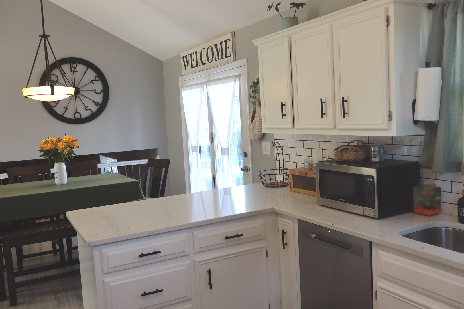 24930 Cashel Bay Road Manhattan, IL 60442 - Photo 11 of 24 a kitchen with a white cabinets and chairs
