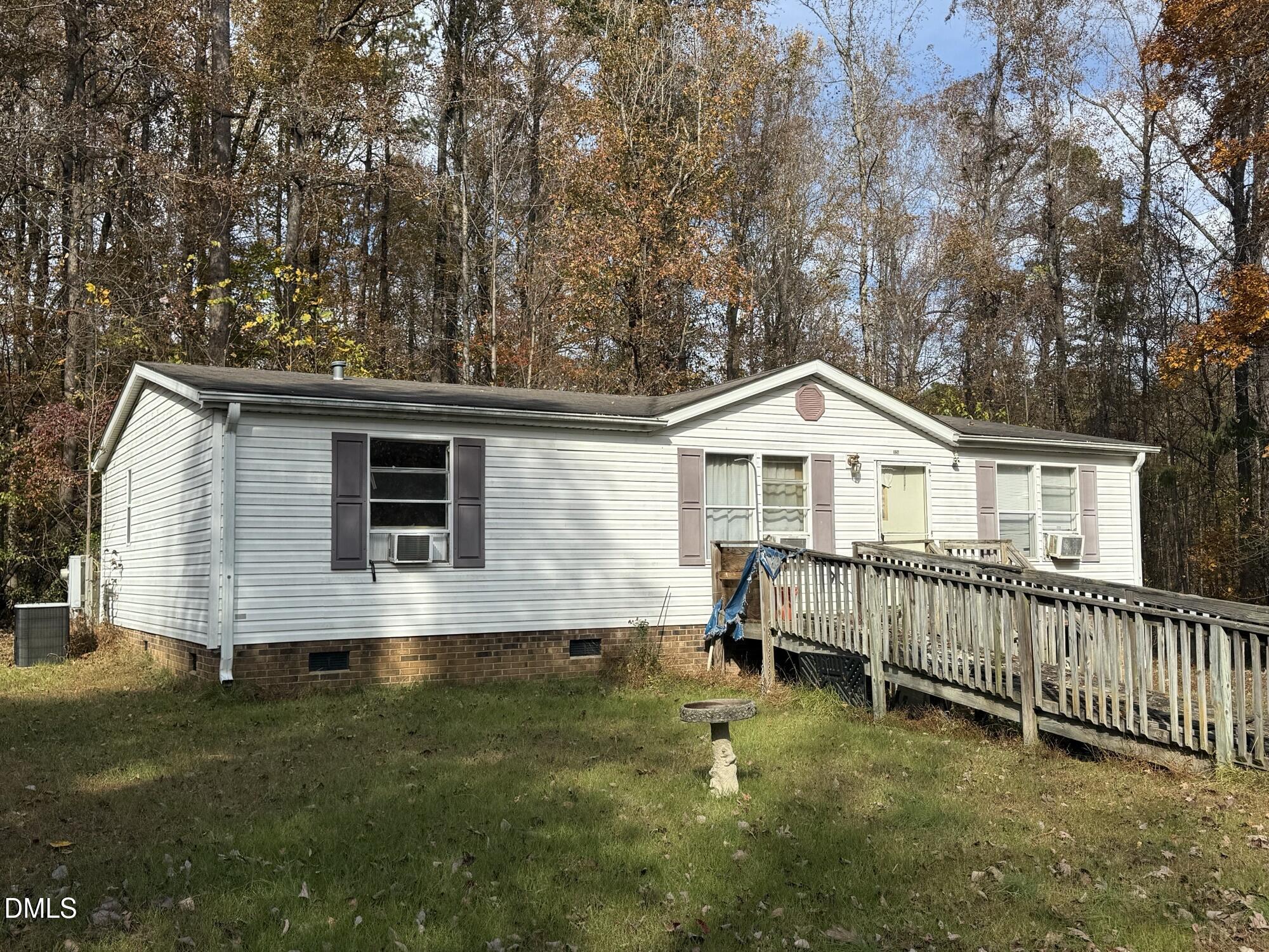 326 Gaines Chapel Road Efland, NC 27243 - Photo 2 of 4 a view of a house with a yard and a wooden deck