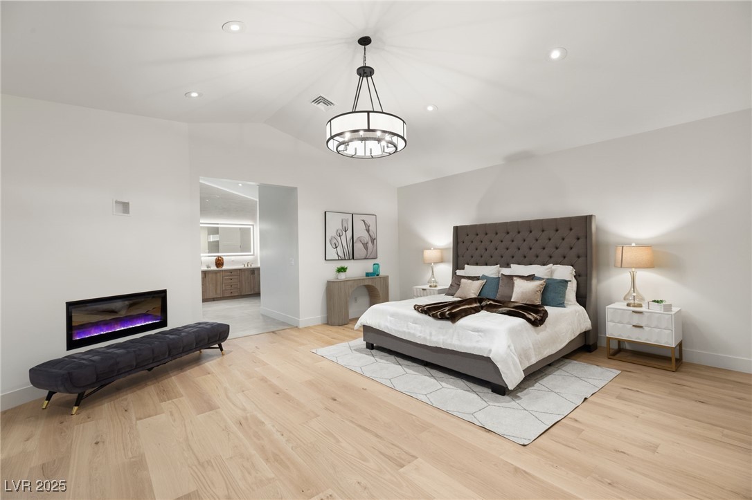 2316 Prometheus Court Henderson, NV 89074 - Photo 42 of 92 Bedroom with wood finished floors, baseboards, visible vents, and a notable chandelier