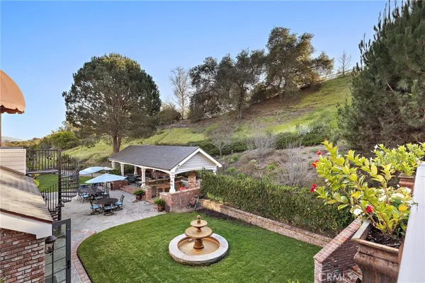 an aerial view of a house with a yard and lake view